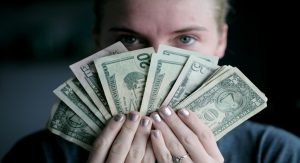 girl holding 20 dollar bill