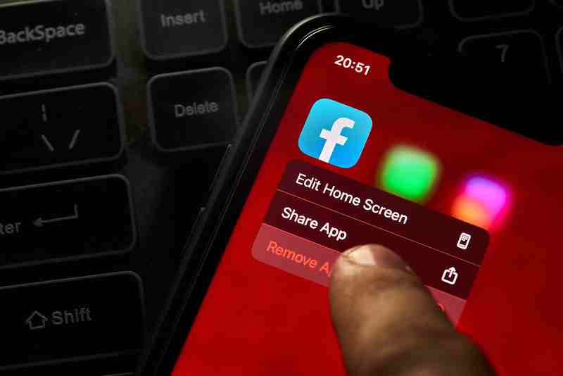 A person removing facebook app